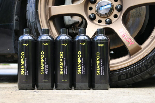 plux bottles in front of clean car wheels and rims